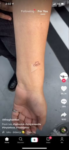 someone is holding their hand up to show the tattoo on her wrist, which reads following for you