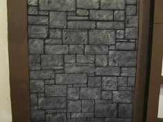 a stone wall in the corner of a room