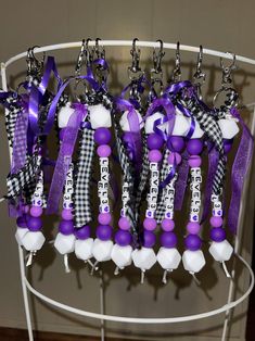 some purple and white items are hanging on a rack