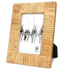 a bamboo frame with three zebras on the front and one in the back, against a white background