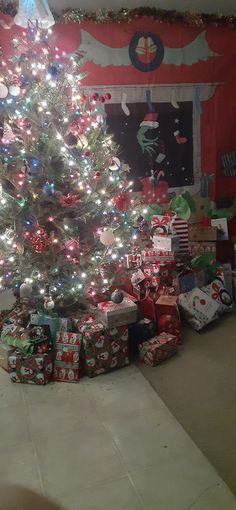 a decorated christmas tree with presents under it