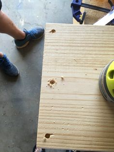 a person using a sanding machine on a piece of wood that is being worked on