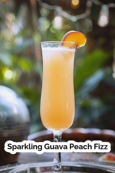 a glass filled with liquid sitting on top of a table next to an orange slice