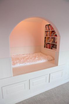 there is a bed with bookshelves in the room