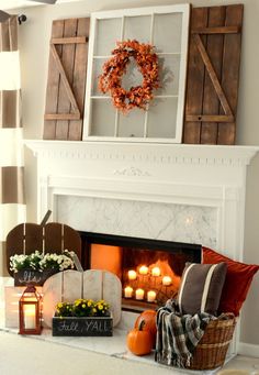 the fireplace is decorated with candles and wreaths