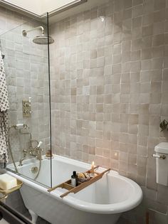 a bath tub sitting next to a toilet in a bathroom