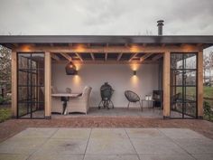 a covered patio area with chairs and tables