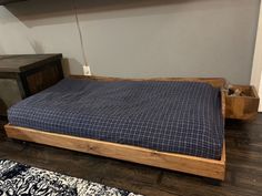 a bed sitting on top of a wooden platform