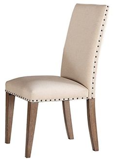 a beige upholstered chair with studded wooden legs