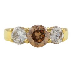 three stone gold ring with brown and white diamonds