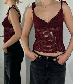 a woman is standing in front of a mirror with her hands on her hips and wearing black jeans