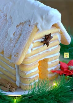 a gingerbread house decorated with icing and cinnamon stars