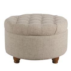 a round ottoman with wooden legs and a buttoned up seat on the back side