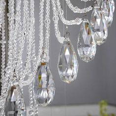 a chandelier with crystal drops hanging from it's sides in a room