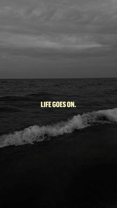 a black and white photo with the words life goes on