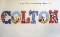 the word cotton is made out of wooden letters with cars and trucks painted on them