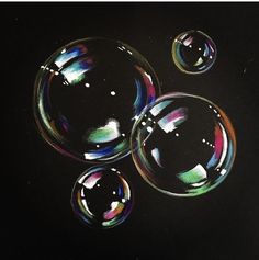 three soap bubbles floating on top of each other