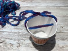 a cup that has some yarn in it