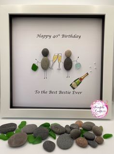 a birthday card with three rocks and two champagne glasses