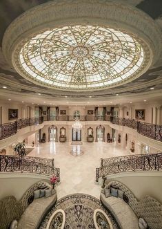 the inside of a large building with lots of windows and chandeliers in it