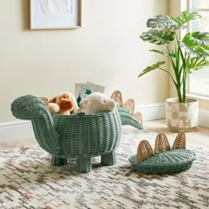 there is a stuffed animal in the basket on the floor next to a potted plant