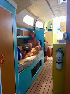 a man sitting on top of a bunk bed with a laptop computer in his lap