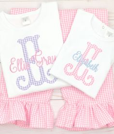 This sweet shirt & ruffle pant set is made from our bright pink gingham fabric & paired with a periwinkle blue embroidered name. Purple gingham pant set available too, please message us! Our white boutique bodysuits & shirts are the highest quality on the market. They are thick, soft & beautifully constructed. They run true to size. We recommend to size up if unsure. Our ruffle pants are made from beautiful, high quality, floral printed fabric. They have an elastic waistband &amp Spring Family Matching Pink Sets, Family Matching Pink Sets For Spring, Pink Monogrammed Cotton Top, Pink Monogram Cotton Top, Personalized Pink Tops For Spring, Personalized Pink Top For Spring, Pink Top For First Birthday In Spring, Pink Tops For First Birthday In Spring, Pink Cotton Tops For First Birthday