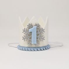 a blue and white crown with a number one on it