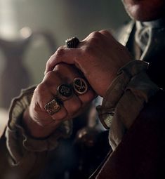 a close up of a person holding two rings