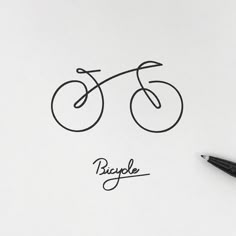 a drawing of a bicycle on top of a piece of paper next to a pen