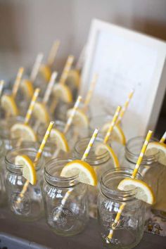 lemon slices and straws are arranged in mason jars