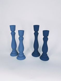 three blue candlesticks sitting next to each other