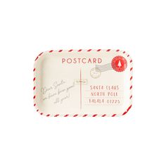 a red and white postcard shaped tray with writing on the front, along with an envelope to santa claus