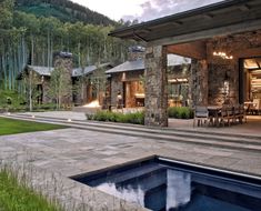 a house with a pool in front of it and lots of grass on the ground