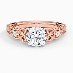 a rose gold engagement ring with a round diamond in the center