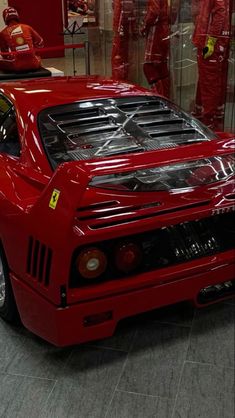 a red sports car is parked in a showroom