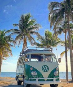 a vw bus parked on the beach with palm trees