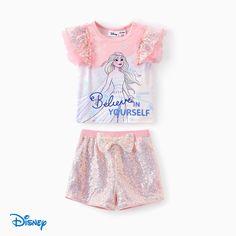 Adorable outfit featuring Disney's Tinkerbell. Perfect for stylish toddlers who love to play.
* Product features: Tinkerbell design with sparkling accents. 
* Fabric characteristics: Soft and breathable materials. 
* Piece of product: 1 Short-sleeved pink t-shirt and 1 matching bow shorts. 
* Neckline: Round neck. 
* Sleeves: Flutter sleeves. 
* Style: Cute and playful. 
* Fit: Comfortable and true to size. Tinkerbell Design, Character Letters, Bow Shorts, Sleeves Style, Pink T Shirt, Flutter Sleeve Top, Pink Tshirt, Flutter Sleeves, Disney Frozen