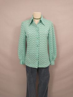 "Fun authentic vintage seventies dacron polyester blouse. Washable (washed, hang dry) . Full button down with classic shirt collar, long length. Double button on each wrist cuff. Size marked 14, vintage sizing is different - please go by measurements, it is on a 6 dress form and there is room.  Long sleeves. Condition very good, no stains or damage. Length 26\" Shoulders 17\" Bust 37\" Sleeve 23.5\" wt 7oz" Retro Long Sleeve Blouse For Vintage Fashion, Vintage Green Button-up Shirt, Retro Collared Blouse For Work, Retro Green Cotton Blouse, Retro Collared Button Blouse, Retro Green Button-up Blouse, Retro Button-up Blouse For Fall, Vintage Button-up Blouse For Fall, Vintage Cotton Shirt With Collared Neckline