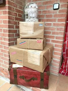 three suitcases are stacked on top of each other in front of a brick wall