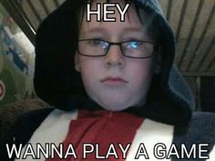 a young boy wearing glasses and a hoodie with the caption hey wanna play a game