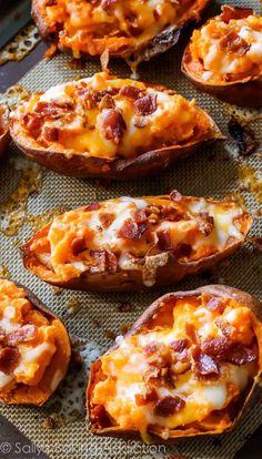 baked sweet potatoes with cheese and bacon on a baking sheet, ready to be eaten