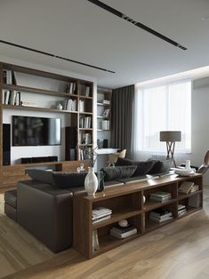 a living room filled with furniture and a flat screen tv sitting on top of a wooden shelf