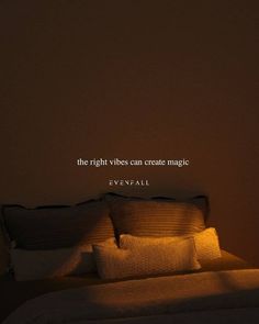 a bed with two pillows and a quote on the wall above it that says, the right vibes can create magic