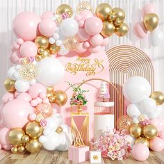 a pink and gold birthday party with balloons