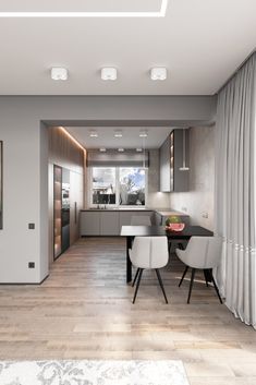 a modern kitchen with wood floors and white chairs