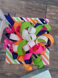 colorful streamers are tied to the side of a box