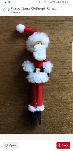 a santa clause ornament hanging on a wooden table with the caption pinpoint santa clothepin obama