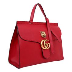 This limited edition Gucci GG Marmont Top Handle Bag is from the coveted Animalier collection. This once-in-a-lifetime bag is a classic luxury handbag that is a beautiful addition to any designer handbag lovers closet. This stunning Gucci Marmont Bag is crafted from red leather, features flat handle with knot on one end, flap top with GG logo and animalier dietail on top, tonal stitching detail, and aged gold-tone hardware. Its push-lock closure opens to a beige canvas interior with zip and slip Designer Handheld Satchel With Top Carry Handle, Designer Handheld Bags With Gold-tone Hardware, Luxury Top Handle Bags For Daily Use, Luxury Handheld Bag With Top Carry Handle, Designer Satchel With Gold-tone Hardware For Daily Use, Designer Handheld Bag With Branded Hardware, Designer Shoulder Bag With Handle Drop As Gift, High-end Bags As A Gift, Luxury Handheld Bags With Detachable Strap