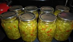 several jars filled with pickles and carrots